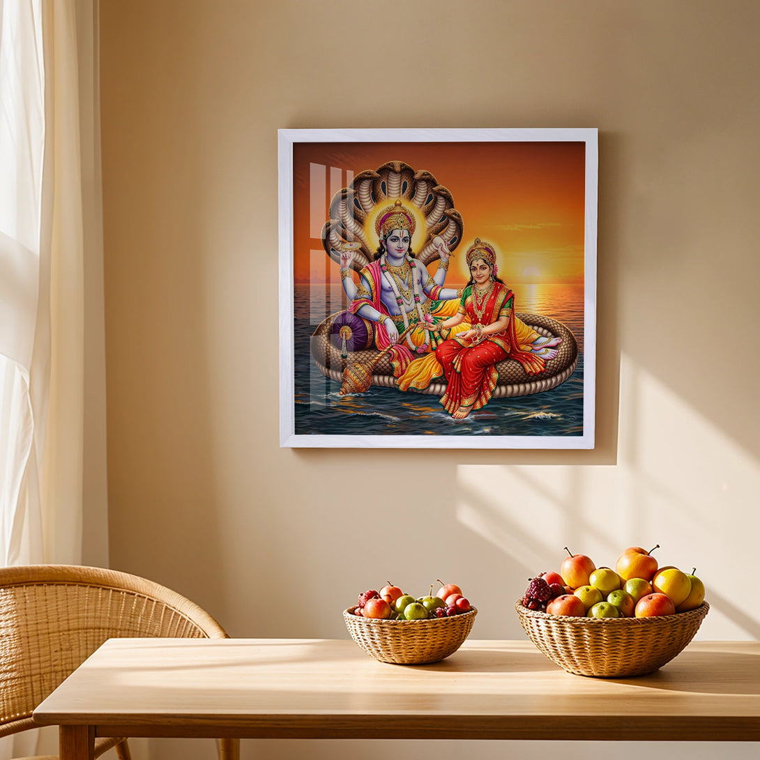 White framed Vishnu Lakshmi art print on serene ocean sunset backdrop
